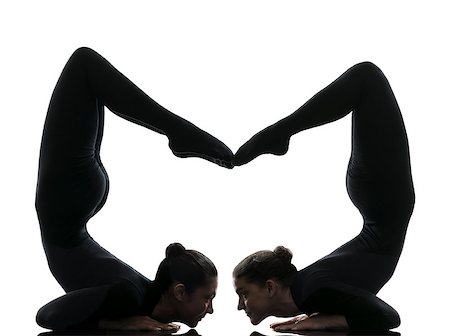 two women contortionist practicing gymnastic yoga in silhouette on white background Stock Photo - Budget Royalty-Free & Subscription, Code: 400-07973212