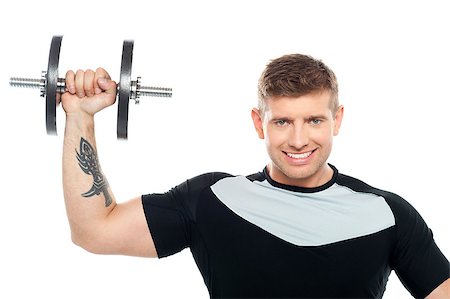 simsearch:400-06859193,k - Half length portrait of young male instructor posing with raised dumbbell Stock Photo - Budget Royalty-Free & Subscription, Code: 400-07988604