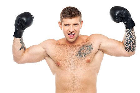 simsearch:400-06859193,k - Attractive young boxer posing strongly with raised arms. Won fight Stock Photo - Budget Royalty-Free & Subscription, Code: 400-07988617