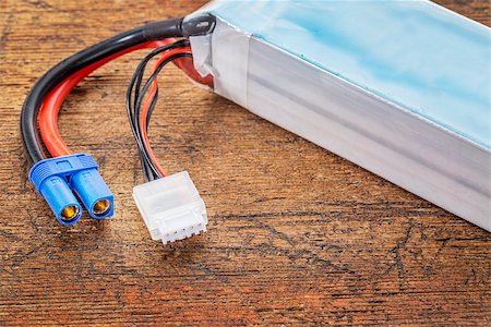 polymer - Lithium-ion polymer rechargeable battery (abbreviated as LiPo, LIP, Li-poly) with balancing and main power plugs. LiPo batteries are used in portable electronics, drones and radio controlled models. Stock Photo - Budget Royalty-Free & Subscription, Code: 400-07981604