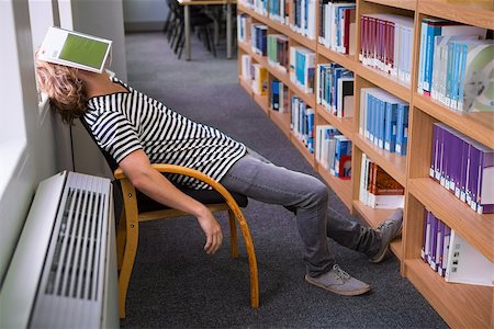 Student asleep in the library with book on his face at the university Stock Photo - Budget Royalty-Free & Subscription, Code: 400-07990791