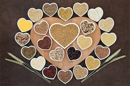 Grain food selection on a heart shaped wooden board and in porcelain bowls with wheat ears over lokta paper background. Photographie de stock - Aubaine LD & Abonnement, Code: 400-07992988