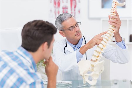 spinal cord of a male - Doctor explaining anatomical spine to his patient in medical office Stock Photo - Budget Royalty-Free & Subscription, Code: 400-08018432