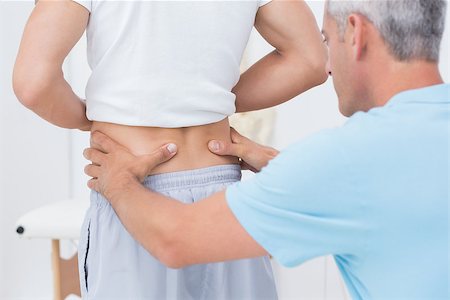 picture of the spine and hips - Doctor examining his patient back in medical office Stock Photo - Budget Royalty-Free & Subscription, Code: 400-08018496