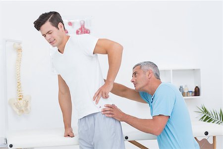 picture of the spine and hips - Doctor examining his patient back in medical office Stock Photo - Budget Royalty-Free & Subscription, Code: 400-08018497