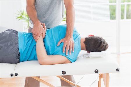 simsearch:400-05318677,k - Doctor examining his patient back in medical office Stock Photo - Budget Royalty-Free & Subscription, Code: 400-08018627