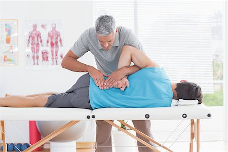 simsearch:400-05318677,k - Doctor examining man back in medical office Stock Photo - Budget Royalty-Free & Subscription, Code: 400-08018623