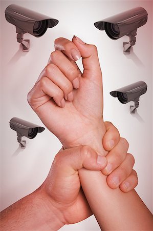 Male hand grabbing female wrist against cctv camera Stock Photo - Budget Royalty-Free & Subscription, Code: 400-08019208