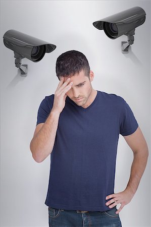 Man with headache against cctv camera Stock Photo - Budget Royalty-Free & Subscription, Code: 400-08019227