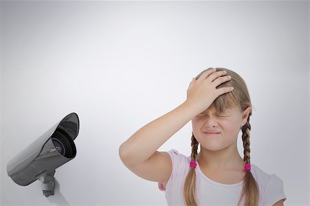Little girl suffering from headache and touching her head  against cctv camera Stock Photo - Budget Royalty-Free & Subscription, Code: 400-08019221