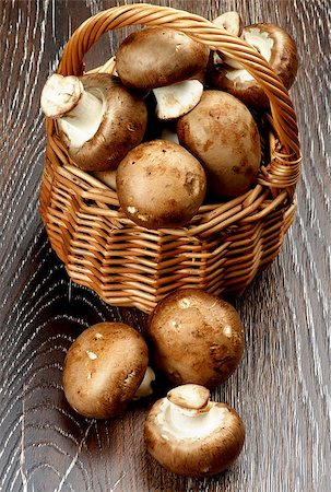 simsearch:400-05738552,k - Fresh Raw Portabello Mushrooms in Wicker Basket closeup on Dark Wooden background Stock Photo - Budget Royalty-Free & Subscription, Code: 400-08011308