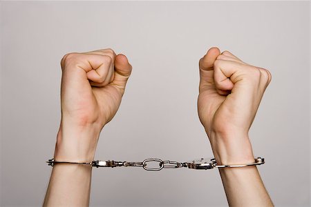 Unreconizable teenager with handcuffs on grey background Stock Photo - Budget Royalty-Free & Subscription, Code: 400-08011721