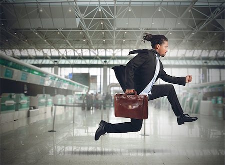 people running scared - Businessman runs in the airport because late Stock Photo - Budget Royalty-Free & Subscription, Code: 400-08035070