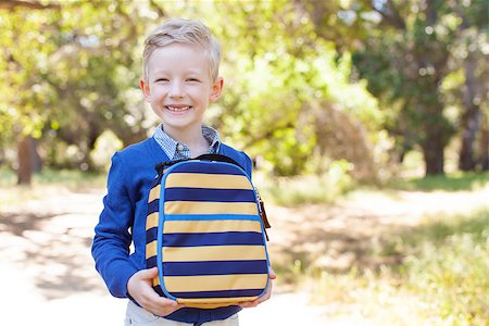 simsearch:695-03381153,k - smiling little schoolboy holding lunchbag ready to go to school, back to school concept Stock Photo - Budget Royalty-Free & Subscription, Code: 400-08047830