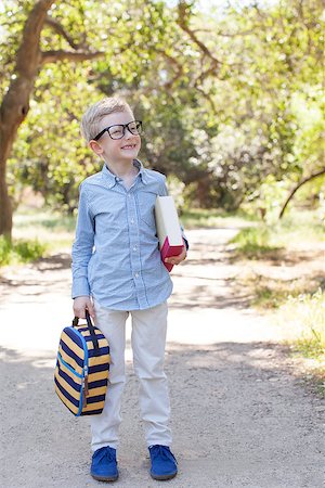 simsearch:695-03381153,k - cute little schoolboy in glasses holding book and lunchbag ready to go to school, back to school concept Stock Photo - Budget Royalty-Free & Subscription, Code: 400-08047832