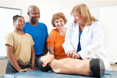 simsearch:400-07411030,k - Adult education class, teaching first aid CPR using a state of the art doll. Stock Photo - Budget Royalty-Free & Subscription, Code: 400-08040640