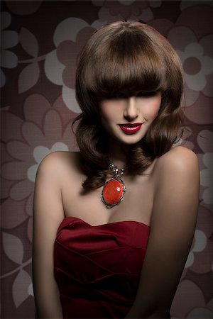 Pretty, mysterious, gorgeous woman with smooth brown hair with straight fringe wearing red, satin top, big old necklace and red lipstick, her eyes are in shadow. Stock Photo - Budget Royalty-Free & Subscription, Code: 400-08052407