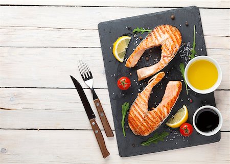 Grilled salmon, salad and condiments on wooden table. Top view with copy space Stock Photo - Budget Royalty-Free & Subscription, Code: 400-08074901