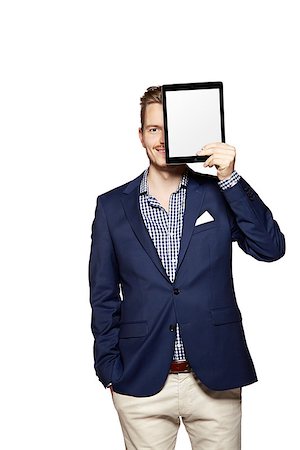 face to internet technology - Portrait of a cheerful young businessman holding a blank digital tablet. Photographie de stock - Aubaine LD & Abonnement, Code: 400-08093633