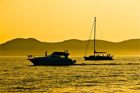 simsearch:400-07748817,k - Yacht and sailboat silhouette at golden sunset view Stock Photo - Budget Royalty-Free & Subscription, Code: 400-08093753