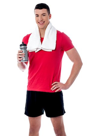 simsearch:400-06482604,k - Young fitness man holding sipper, towel around his neck Stock Photo - Budget Royalty-Free & Subscription, Code: 400-08108160