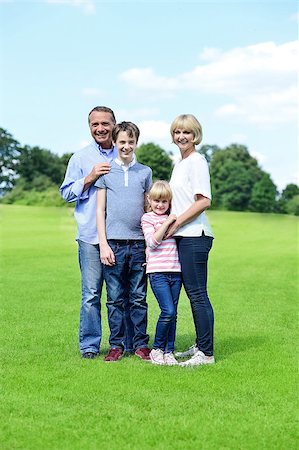 simsearch:400-07426233,k - Happy family of four standing together on the meadow Stock Photo - Budget Royalty-Free & Subscription, Code: 400-08108997