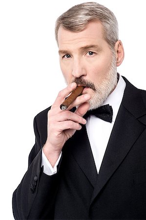 Senior businessman relaxing with cigar Stock Photo - Budget Royalty-Free & Subscription, Code: 400-08109603