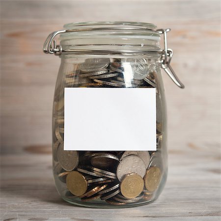 simsearch:656-03241003,k - Coins in glass money jar with white blank label, financial concept. Vintage wooden background with dramatic light. Stock Photo - Budget Royalty-Free & Subscription, Code: 400-08114042