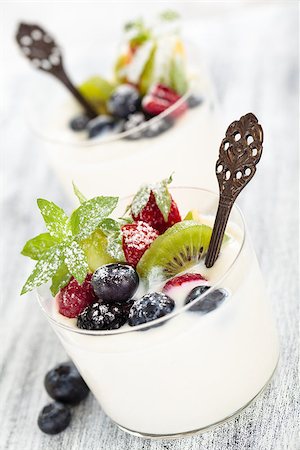 simsearch:400-05891431,k - Fresh yogurt with berries. On white rustic table. Focus on mint leaves and kiwi and blueberry in the center of the first glass. Stock Photo - Budget Royalty-Free & Subscription, Code: 400-08110675
