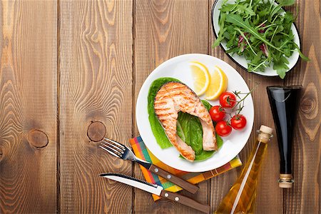 Grilled salmon, salad and condiments on wooden table. Top view with copy space Stock Photo - Budget Royalty-Free & Subscription, Code: 400-08111966