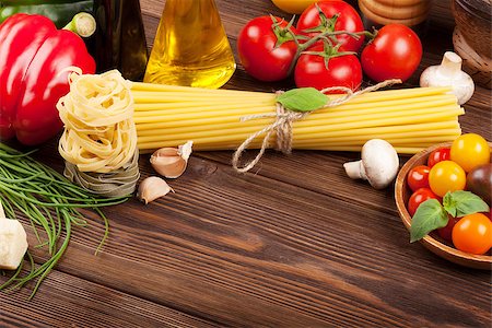 simsearch:400-06796273,k - Italian food cooking ingredients. Pasta, tomatoes, basil on wooden table with copy space Stock Photo - Budget Royalty-Free & Subscription, Code: 400-08111977