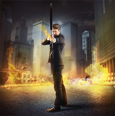 Businessman with bow and arrow on fire Stock Photo - Budget Royalty-Free & Subscription, Code: 400-08112394