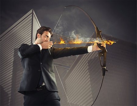 Determinated businessman with flaming arrow takes aim Stock Photo - Budget Royalty-Free & Subscription, Code: 400-08112395