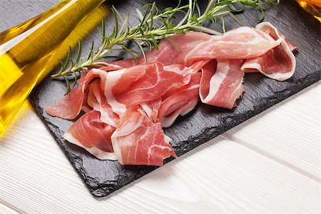 simsearch:400-06207145,k - Prosciutto with rosemary and olive oil on wooden table Stock Photo - Budget Royalty-Free & Subscription, Code: 400-08112915