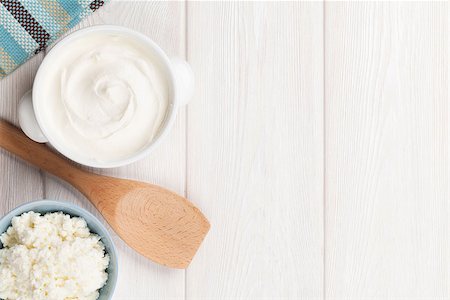 Dairy products on wooden table. Sour cream and curd. Top view with copy space Stock Photo - Budget Royalty-Free & Subscription, Code: 400-08112910