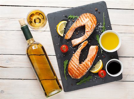 Grilled salmon and white wine on wooden table. Top view Stock Photo - Budget Royalty-Free & Subscription, Code: 400-08113646