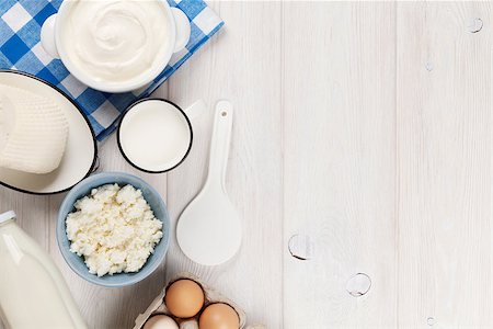 Dairy products on wooden table. Sour cream, milk, cheese, eggs and yogurt. Top view with copy space Stock Photo - Budget Royalty-Free & Subscription, Code: 400-08113685