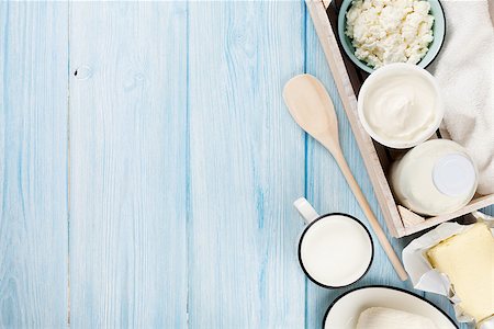 Dairy products on wooden table. Sour cream, milk, cheese, yogurt and butter. Top view with copy space Stock Photo - Budget Royalty-Free & Subscription, Code: 400-08113683