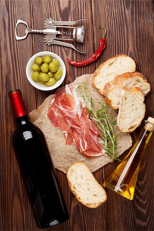 simsearch:400-06207145,k - Prosciutto, wine, olives, parmesan and olive oil on wooden table. Top view Stock Photo - Budget Royalty-Free & Subscription, Code: 400-08113696