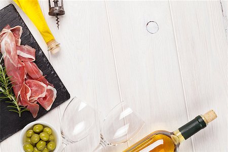 simsearch:400-06207145,k - Prosciutto, wine, olives and olive oil on wooden table. Top view with copy space Stock Photo - Budget Royalty-Free & Subscription, Code: 400-08113692