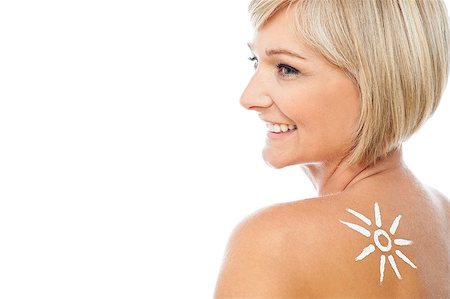 Tanning lotion in the shape of sun on woman's shoulder Stock Photo - Budget Royalty-Free & Subscription, Code: 400-08131098