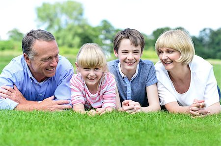 simsearch:400-07426233,k - Fun filled family of four relaxing in park Stock Photo - Budget Royalty-Free & Subscription, Code: 400-08131149