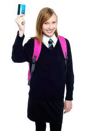 simsearch:400-06858518,k - Joyous teen girl in uniform holding up a cash card and showing it to the camera. Stock Photo - Budget Royalty-Free & Subscription, Code: 400-08151589