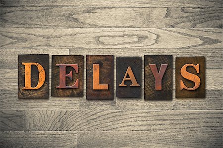 The word "DELAYS" theme written in vintage, ink stained, wooden letterpress type on a wood grained background. Stock Photo - Budget Royalty-Free & Subscription, Code: 400-08152393