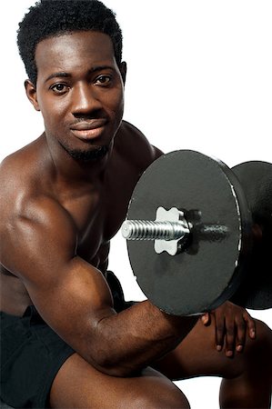 simsearch:400-06482604,k - Powerful young man lifting weights. Looking at camera while exercising Stock Photo - Budget Royalty-Free & Subscription, Code: 400-08152926