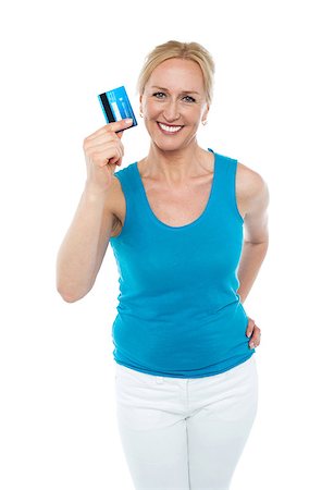 simsearch:400-06858518,k - Trendy middle aged woman showing credit card to camera with hand on her waist Stock Photo - Budget Royalty-Free & Subscription, Code: 400-08153098