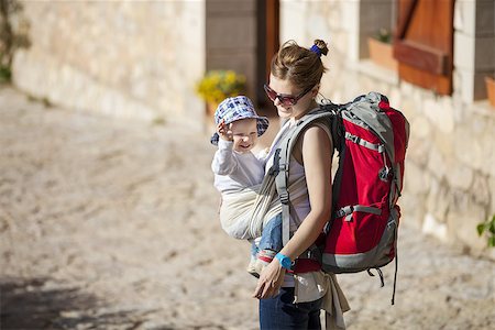 Young woman tourist carrying her little son in sling Stock Photo - Budget Royalty-Free & Subscription, Code: 400-08153641