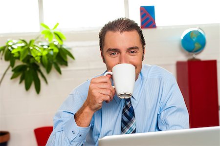 Handsome boss sipping coffee during work break. Stock Photo - Budget Royalty-Free & Subscription, Code: 400-08185762