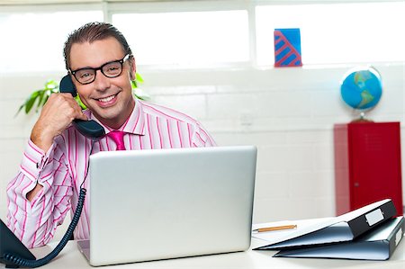 Cheerful boss clinched the deal over a phone call. Success at business. Stock Photo - Budget Royalty-Free & Subscription, Code: 400-08185770