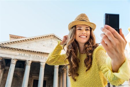 A woman tourist smiles as she is taking a selfie, cheering as she is standing near the Pantheon in Rome on a summer's day. Stock Photo - Budget Royalty-Free & Subscription, Code: 400-08189793